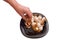 Woman takes garlic from black plate, isolated, spicy seasoning. Horizontal photo, home cooking concept