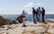 Woman takes photo of a family at Bingi Bingi point. NSW. Australia