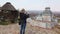 Woman takes a photo near a miniature Chinese Japanese pagoda. Park of Miniatures.