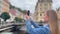 A woman takes a photo with a smartphone. A stylish summer trip to the Old Town of Karlovy Vary