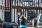 Woman takes photos of half-timbered medieval cottages in Lavenham, Suffolk, England, UK