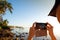 Woman takes picture of two surfers