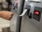 A woman takes a printed check from an ATM.