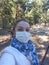 woman takes selfie on smartphone in medical mask to protect against viral epidemic, protection against coronavirus