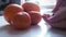 Woman takes Vitamin C to hand with background of oranges on table Close up