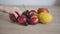 Woman taking apple from the table