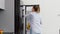 Woman taking banana from fridge at home kitchen