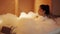 Woman taking a bubble bath in the bathtub at night