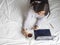 Woman taking a call in pijama in bed drinking coffee in the morning.