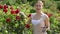 woman taking care of red rose