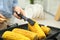 Woman taking corn from grill pan with tongs in kitchen