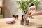 Woman taking cosmetic products for makeup from organizer on dressing table, closeup.