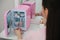 Woman taking face roller out of cosmetic refrigerator, closeup