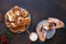 Woman taking freshly baked cinnamon buns from plate