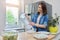 Woman taking ice cubes into bowl in kitchen