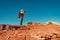 Woman taking landscape photos in Arizona standing on a rock.