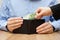 Woman is taking money out of a husband\'s wallet