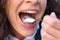 Woman taking a mouthful of cream or ice cream