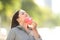 Woman taking off mask breathing fresh air outdoors