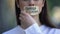 Woman taking off tape with freedom of speech phrase in russian over mouth