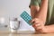 Woman taking oral contraception pill at wooden table indoors, focus on hand