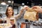 Woman taking paper bag from seller at cafe