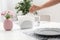 Woman taking paper tissue from ceramic napkin holder