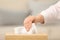 Woman taking paper tissue from holder indoors, closeup