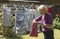 Woman taking pegs from a peg bag to hang washing