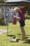 Woman taking pegs from a peg bag to hang washing