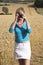 Woman taking a photo of farmland