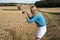 Woman taking a photo of farmland