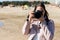 Woman taking photo front view with DSLR camera