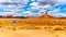 Woman taking a photo of the landscape of Red Sandstone Buttes and Pinnacles in the semi desert landscape in the Valley of the Gods