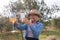 Woman taking a photo of wine glass in olives farm