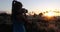 Woman taking photos on Paradise beach sunset with tropical palm trees. Summer travel holidays vacation getaway colorful