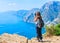 Woman taking photos of Path of Gods on Tyrrhenian sea