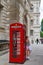 Woman taking picture with the red telephone booth