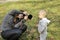 Woman taking pictures of a little boy