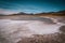 Woman taking pictures in a salt flat desert.