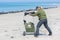 Woman taking pictures of seals at beach of island Dune