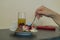 Woman taking a piece from the delicious blackberry cake with white cream