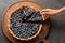 Woman taking piece of delicious blueberry pie, top view