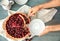 Woman taking piece of tasty homemade cherry pie from table