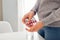 Woman taking pills with glass of water on kitchen. Healthcare and medicine