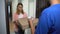 Woman taking pizza, paying euros to man, satisfied with timely delivery, service