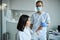 Woman taking a routine spirometry test helped by a physician