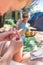 Woman taking sea urchin spine out of her friends sole using medical needle.