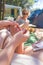 Woman taking sea urchin spine out of her friends sole using medical needle.