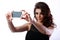 Woman taking self picture with smartphone